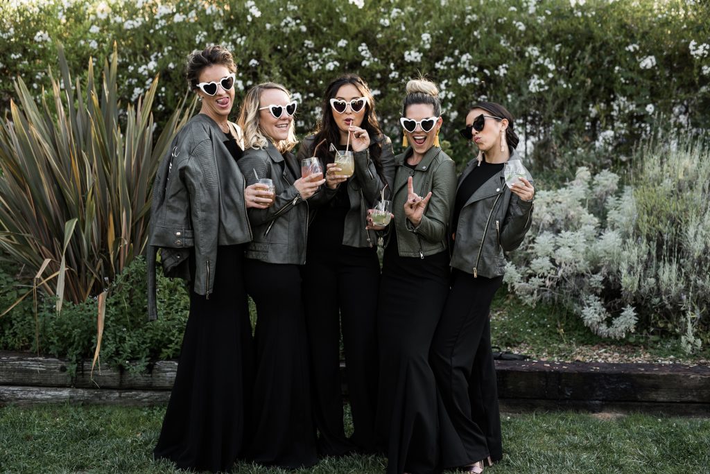 rad bridesmaids with black jumpsuits and leather jackets