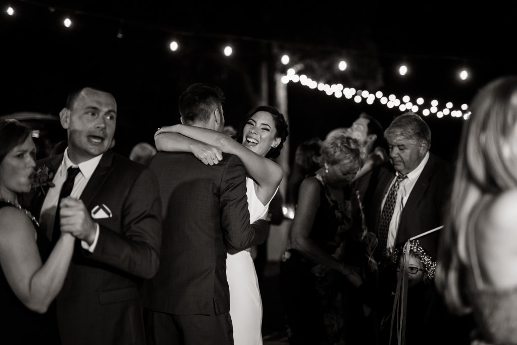 bride and groom dancing with their loved ones