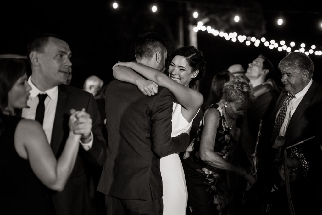 loved ones joining bride and groom for their first dance