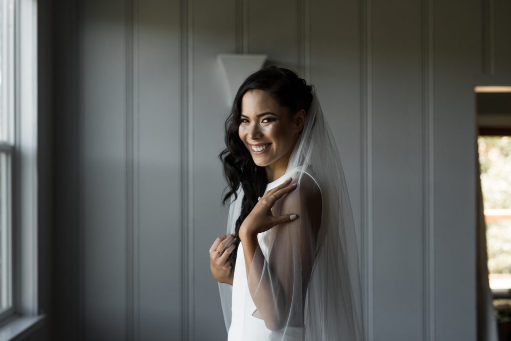 bride getting ready in her modern minimalist wedding gown