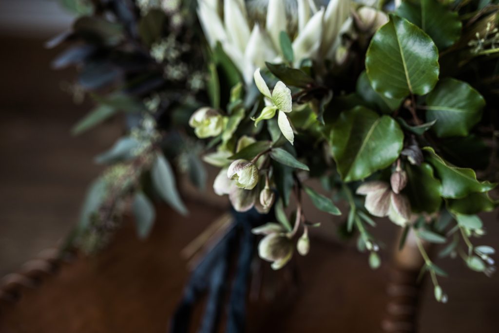 closeup of a greenery bouquet with hellebore flowers