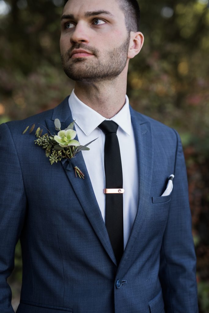 groom wearing a sleek blue suit