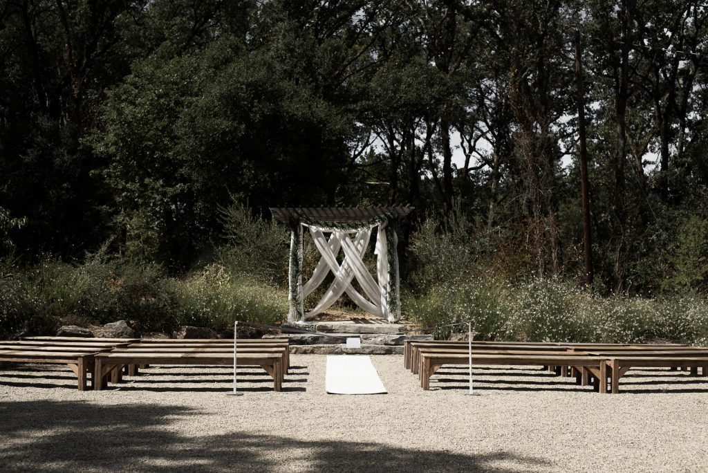 simple ceremony setting with wood benches